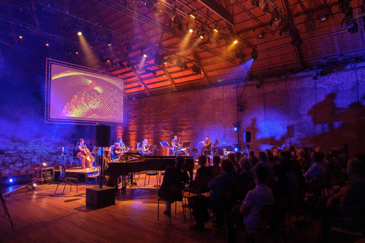 Subatomic by Christo Squier. Concert with projections of subatomic particles at snape maltings concert hall.