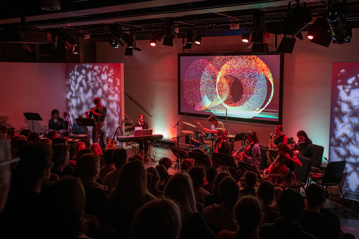 Subatomic by Christo Squier. A live concert with projections, a chamber orchestra and a lecture about subatomic particles at Science Gallery London.