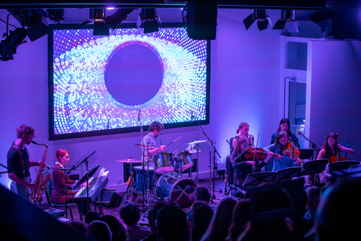 Subatomic by Christo Squier. A live concert with projections, a chamber orchestra and a lecture about subatomic particles at Science Gallery London.