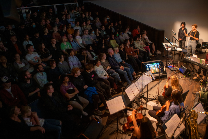 Subatomic by Christo Squier. A live concert with projections, a chamber orchestra and a lecture about subatomic particles at Science Gallery London.