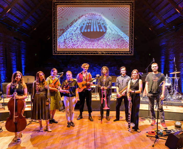 Subatomic by Christo Squier and Dr. Teppei Katori. A Concert with projections of subatomic particles at snape maltings concert hall.